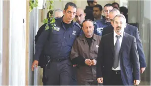  ?? (Reuters) ?? SOME FATAH officials insist that Marwan Barghouti (center), who is currently jailed for murdering Israelis during the Second Intifada, will run in the next PA election.