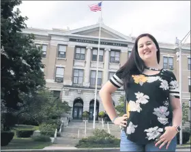  ?? CHARLES KRUPA — THE ASSOCIATED PRESS ?? Kayleigh Bergh, of Haverhill, Mass., stands outside city hall, across the street from the polling station where she will be working on Election Day.