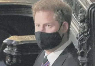  ?? PHOTO: GETTY ?? Prince Harry in a mask in St George’s Chapel.