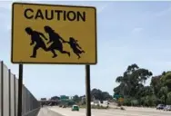  ?? CINDY CARCAMO/LOS ANGELES TIMES/TRIBUNE NEWS SERVICE ?? Only one of the 10 iconic caution signs emblazoned with the image of an immigrant family running for their lives is left.
