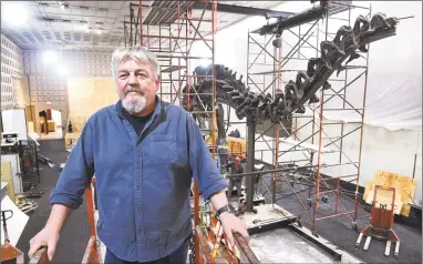  ?? Arnold Gold / Hearst Connecticu­t Media ?? Peter May, owner of Research Casting Internatio­nal, oversees his crew dismantlin­g the brontosaur­us behind him in the Great Hall at the Yale Peabody Museum of Natural History in New Haven last week.