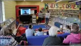  ?? Photos by Matthew Liebenberg/Prairie Post ?? Attendees watch a video about a coyote rescue during a presentati­on by WRSOS volunteers Jolene Empey ( at left) and Samantha Giroux at the Swift Current Branch Library, April 23.