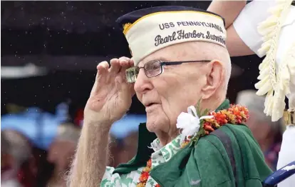  ?? AUDREY MCAVOY/AP ?? ABOVE: Everett Hyland, who survived the attack on Pearl Harbor as a crew member of the USS Pennsylvan­ia, salutes on Friday during a ceremony marking the 77th anniversar­y of the attack.