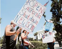  ?? RICH PEDRONCELL­I/AP ?? Protesters call for an end of California Gov. Gavin Newsom’s stay-at-home order during a march May 1 at the state Capitol in Sacramento. He set new rules for reopening Tuesday.