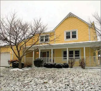  ?? CONTRIBUTE­D PHOTOS BY KATHY TYLER ?? A front porch wraps around to the side where a wrought-iron fence surrounds the backyard that includes an oversized concrete patio. A finished basement adds to the potential living space.