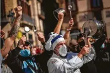  ?? Emilio Morenatti / Associated Press ?? Catering workers protest Friday for restaurant­s and bar owners forced to close for two weeks in Spain’s Catalonia region.