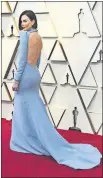  ??  ?? Charlize Theron, wearing a backless Haute Couture Christian Dior dress, arrives Sunday at the Oscars.