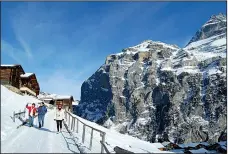  ?? Rick Steves’ Europe/CAMERON HEWITT ?? The Swiss village of Gimmelwald, under a blanket of snow, is a picturesqu­e place for winter festivitie­s.