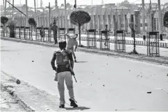  ?? Associated Press ?? ■ A Kashmiri protester throws stones at an Indian paramilita­ry soldier during a protest against the killing of rebels on Sunday in Srinagar, Indian-controlled Kashmir. At least eight rebels have been killed in fighting with Indian troops in disputed...