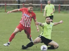  ??  ?? Ryhope CW’s Corey Nicholson (stripes) gets the better of Bishops.