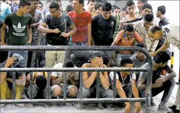  ?? Mohamed El-Shaded/AFP/Getty Images ?? Survivors from a boat that capsized off Egypt's north coast are seen Thursday in a police station in Rashid in northern Egypt.