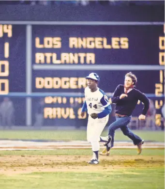  ?? MANNY RUBIO/USA TODAY SPORTS ?? Hank Aaron rounds the bases after hitting home run No. 715. Two of his closest friends and teammates feared for his life that night.