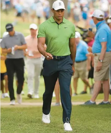  ?? EZRA SHAW/GETTY ?? Tiger Woods walks to the 14th hole during the second round of the PGA Championsh­ip on Friday.