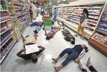  ?? JOE BURBANK/AP ?? Demonstrat­ors against gun violence protest Friday at a Publix store in Orlando. The grocery chain has given contributi­ons to an NRA supporter who is running for Florida governor.