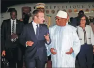  ?? LUC GNAGO / REUTERS ?? French President Emmanuel Macron talks with Malian President Ibrahim Boubacar Keita as he arrives in Bamako, Mali, on Sunday.