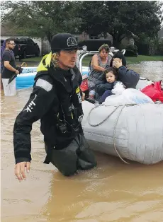 ?? GETTY IMAGES/FILES ?? A Houston woman and her granddaugh­ter are rescued from flood waters in the wake of hurricane Harvey.