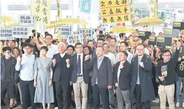  ?? — Reuters photos ?? (From left) Pro-democracy activists Chung Yiu-wa, Cheung Sau-yin, Tanya Chan, Chu, Kin-man, Tai, Shiu and Raphael Wong chant slogans before hearing a verdict on their involvemen­t in the Occupy Central, also known as ‘Umbrella Movement’, in Hong Kong, China.