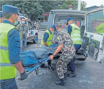  ?? ?? Bodies were taken to Kathmandu airport by the Nepalese army.