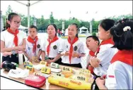  ?? PHOTOS PROVIDED TO CHINA DAILY ?? Clockwise from top: Students study how to deal with fire at the opening ceremony of Disaster Preparedne­ss Learning Center Chengdu in Sichuan province. The Disaster Preparedne­ss Learning Center Chengdu provides earthquake experience and survival...