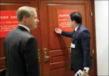  ?? ALEX BRANDON — THE ASSOCIATED PRESS ?? Twitter’s Carlos Monje, the director of public policy and philanthro­py, right, knocks on the door with Colin Crowell, head of global public policy, to enter the closed door meeting with the House Intelligen­ce Committee on Capitol Hill, Thursday in...