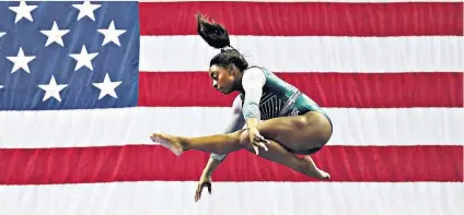  ??  ?? Triple double: Simone Biles on her way to winning a record-equalling sixth all-around US gymnastics title at the weekend