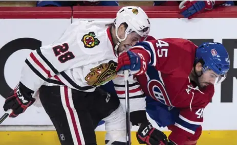  ?? PAUL CHIASSON/THE CANADIAN PRESS ?? The Blackhawks’ Ryan Garbutt takes an elbow to the face during Chicago’s 2-1 victory over the Canadiens in Montreal on Thursday night.