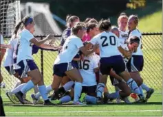  ?? PETE BANNAN — DIGITAL FIRST MEDIA ?? West Chester University players celebrate with freshman Jenny Bail (right, leaning down) after her goal in the final minute secured a huge win over East Stroudsbur­g Tuesday afternoon at Rockwell Field.