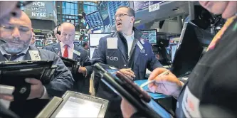  ?? RICHARD DREW THE ASSOCIATED PRESS ?? Traders react to market movements on Wednesday on the floor of the New York Stock Exchange.