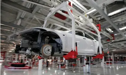  ?? ?? The body of a Tesla Model S is transporte­d by an automated crane at the carmaker’s factory in Fremont, California. Photograph: Stephen Lam/Reuters