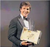  ?? VALERY HACHE/GETTY-AFP ?? Tom Cruise receives an honorary Palme d’or on Wednesday at the Cannes Film Festival.