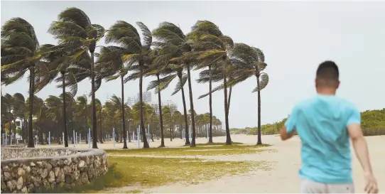  ?? AP PHOTOS ?? STORM’S LONG REACH: Areas across the Southeast were bracing for Hurricane Irma, which shifted west yesterday, with a direct hit on the Florida Keys and St. Petersburg. Above, winds come ashore at Miami Beach. A woman, top, rests during evacuation in...