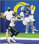  ?? Jae C. Hong / Associated Press ?? Los Angeles Rams defensive back Darious Williams intercepts a pass in the end zone next to Seattle tight end Will Dissly during the Rams’ 23-16 win over the Seahawks.