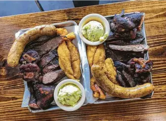  ?? Photos by J.C. Reid / Contributo­r ?? Ray’s BBQ Shack offers a variety of barbecue items, including smoked oxtails.