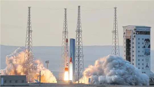  ?? AFP ?? A picture by Iran’s Defence Ministry shows a Simorgh satellite rocket lifting off during its launch at an undisclose­d location in the country.