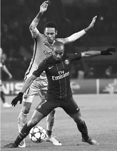  ??  ?? Barcelona’s Brazilian forward Neymar (left) vies with Paris Saint-Germain’s Brazilian midfielder Lucas Moura during the UEFA Champions League round of 16 first leg football match at the Parc des Princes stadium in Paris. — AFP photo