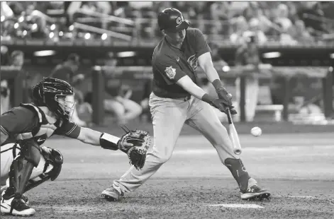  ?? ROSS D. FRANKLIN/AP ?? CHICAGO CUBS’ FRANK SCHWINDEL (RIGHT) connects for a run-scoring single as Arizona Diamondbac­ks catcher Daulton Varsho reaches out with his glove during the ninth inning of a game on Sunday in Phoenix.