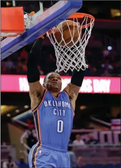  ?? The Associated Press ?? STUFF SHOT: Russell Westbrook dunks for two of his 57 points in a triple-double as visiting Oklahoma City defeats Orlando Wednesday night.