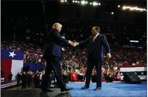  ?? AP/EVAN VUCCI ?? President Donald Trump is greeted by Sen. Ted Cruz, R-Texas, during a campaign rally Monday night at the Toyota Center in Houston.
