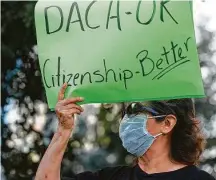  ?? Godofredo A. Vásquez / Staff file photo ?? Alma Cooper holds a sign as people gather in Houston to support DACA recipients in June.