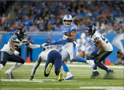  ?? PAUL SANCYA — THE ASSOCIATED PRESS ?? Golden Tate (15) runs after a catch against the Seahawks in Detroit, Sunday.