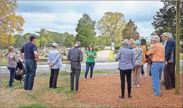  ??  ?? Tour host Arleigh Ordoyne starts the tour off with Greenwood facts.