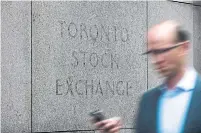  ?? AARON VINCENT ELKAIM THE CANADIAN PRESS ?? The Canadian dollar traded lower at 76.99 cents U.S. compared with an average of 77.13 cents U.S. on Tuesday.