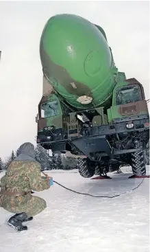  ?? AFP ?? A RUSSIAN strategic nuclear forces (SNF) officer has a practice session, learning how to operate the mobile Topol-m interconti­nental ballistic missile at a secret launching centre of interconti­nental ballistic missiles in December 1998. The Topol-m is 22.7 metres long and has a diameter of 1.95m. The missile has a range of 11 000km. The solid-propellant three-stage Topol-m missile complex, with a standardis­ed (silo and mobile) missile, became the foundation of the Russian strategic nuclear forces in the 21st century. The strategic nuclear forces of the Russian Federation consist of ground interconti­nental ballistic missiles stationary, and also mobile, earth and railway variants of basing, sea and aviation strategic nuclear arms. |