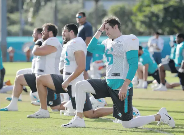  ?? — THE ASSOCIATED PRESS ?? Miami’s newest quarterbac­k, Jay Cutler, right, got his first taste of Dolphins training camp Tuesday, in Davie, Fla.