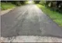  ??  ?? Resident Charlie Albright, who built roads for a living before, said the township’s failure to repave Detwiler Road after this attempted repair means the repair is useless and it is already coming apart.