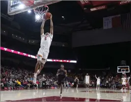  ?? MARCIO JOSE SANCHEZ — THE ASSOCIATED PRESS ?? USC's Boogie Ellis scores on a breakaway dunk during the second half for two of his 33 points in the Trojans' victory over Stanford on Saturday night at the Galen Center.