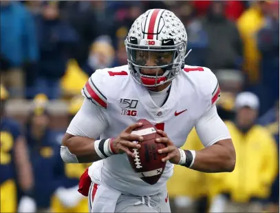  ?? Paul Sancya The Associated Press file ?? Ohio State quarterbac­k Justin Fields is one of several top players mulling whether to leave college for the NFL draft.