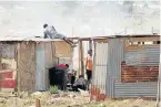  ??  ?? HARD AT WORK: Shacks are erected in ‘Malema Village’ near Govan Mbeki township