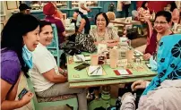 ??  ?? BONDING AGAIN: Older guests share happy moments at a Dubai café as Covid-19 sanctions ease. —