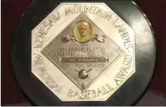  ?? JENNIFER SZYMASZEK — THE ASSOCIATED PRESS FILE ?? Joe DiMaggio’s 1947 MVP Award Plaque is displayed at a 2006 news conference in New York. The plaque features the name and image of Kenesaw Mountain Landis.